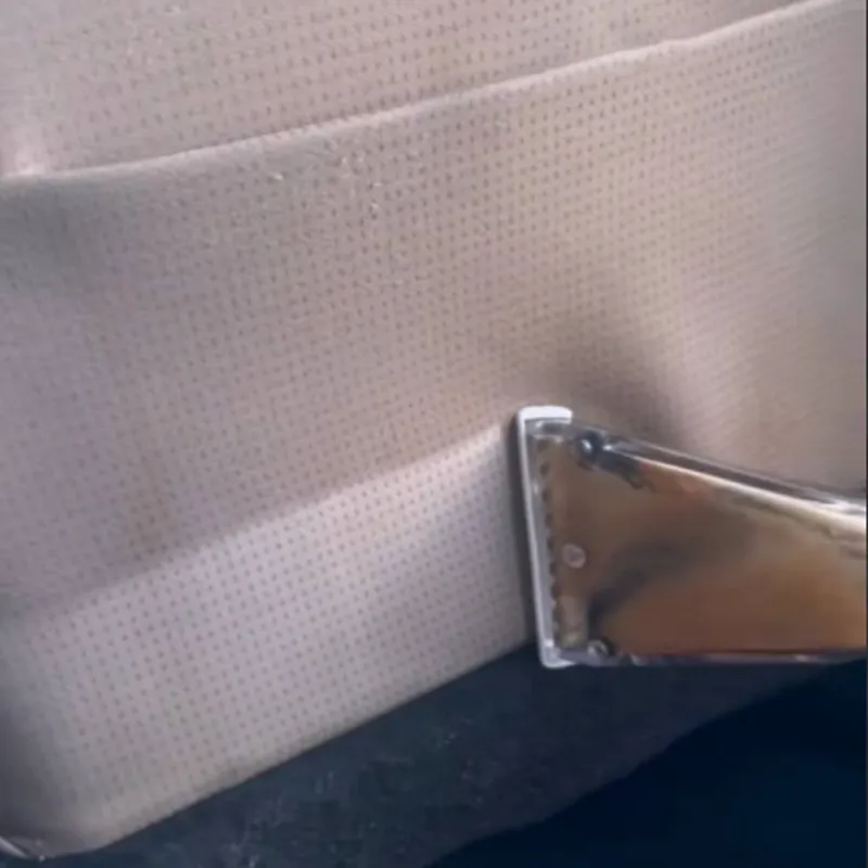 fabric chair seat being cleaned with extractor